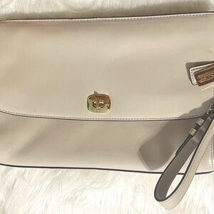 Coach Clutch bag in a dark bone or cream, with removable wristlet and dog tags